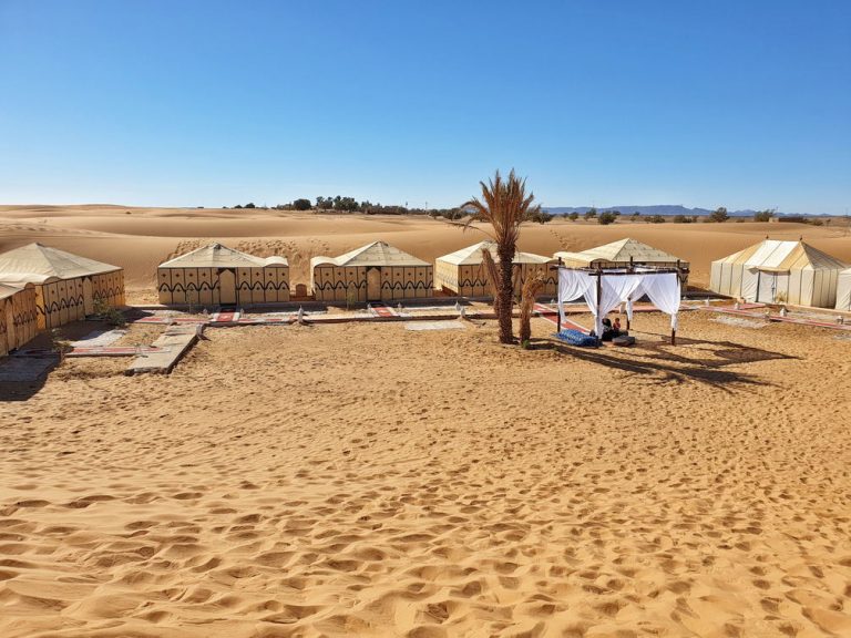 Luxury Sahara desert camp with traditional tents at the Erg Chebbi dunes, the kind of camp included in SaharaTrek Morocco tour pricing