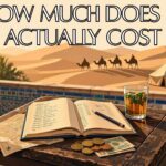 Handwritten travel budget ledger with Moroccan dirham coins and mint tea on a wooden table, Sahara desert camp in the golden background - calculating Morocco tour cost